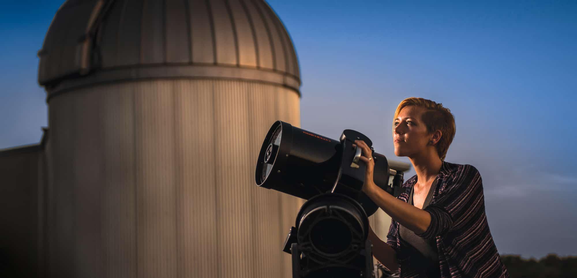 Students viewing stars through a telescope.